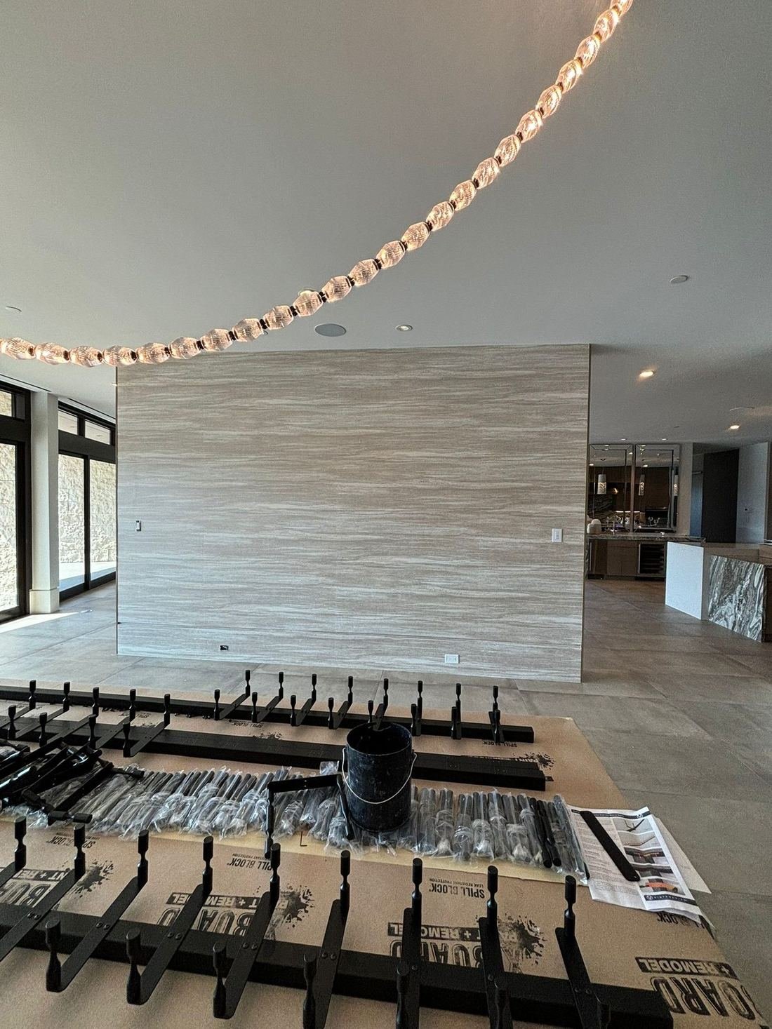 Hotel common area with a stone feature wall and a glass pendant light